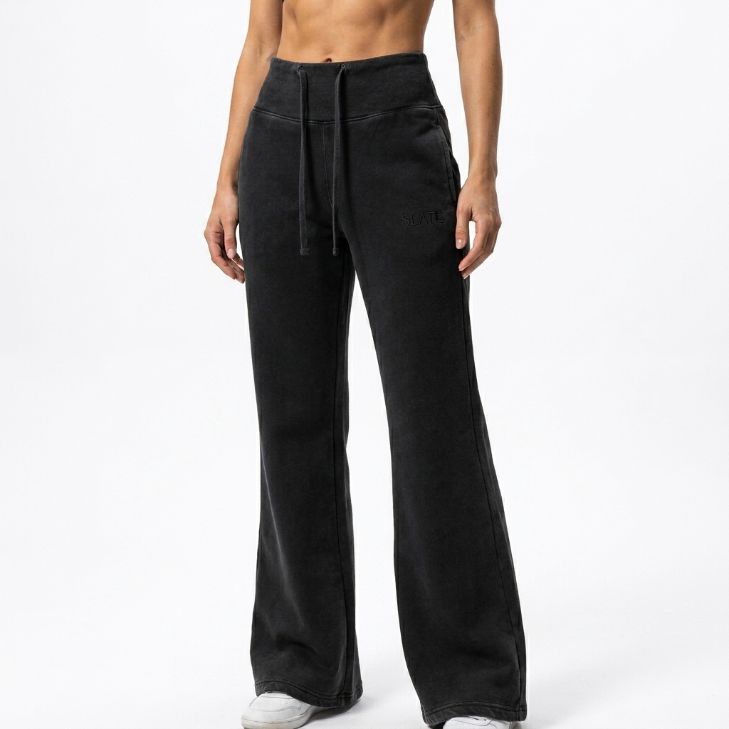 Vintage Washed Flared Fleece Pants worn by a toned German female fashion influencer, preppy ivy styling, studio lookbook — custom vintage washed flared fleece pants