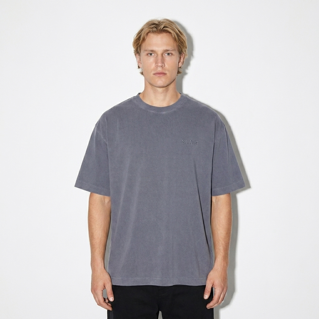 Vintage Washed Oversized T-Shirt worn by a mid-size Scandinavian male fashion influencer, clean-girl minimal styling, studio lookbook — custom vintage washed oversized t-shirt