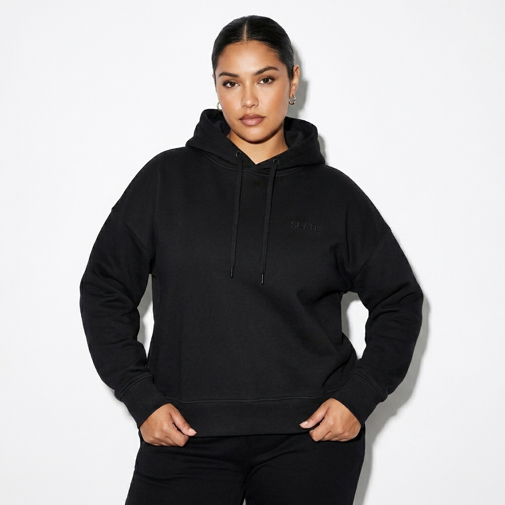 Women's Organic Pullover Hoodie worn by a curvy Latino female fashion influencer, minimalist luxury styling, studio lookbook — custom women's organic pullover hoodie