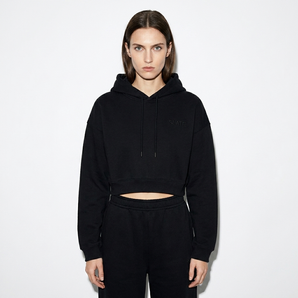Women's Cropped Hoodie worn by a slim tall British female fashion influencer, workwear utility styling, studio lookbook — custom women's cropped hoodie