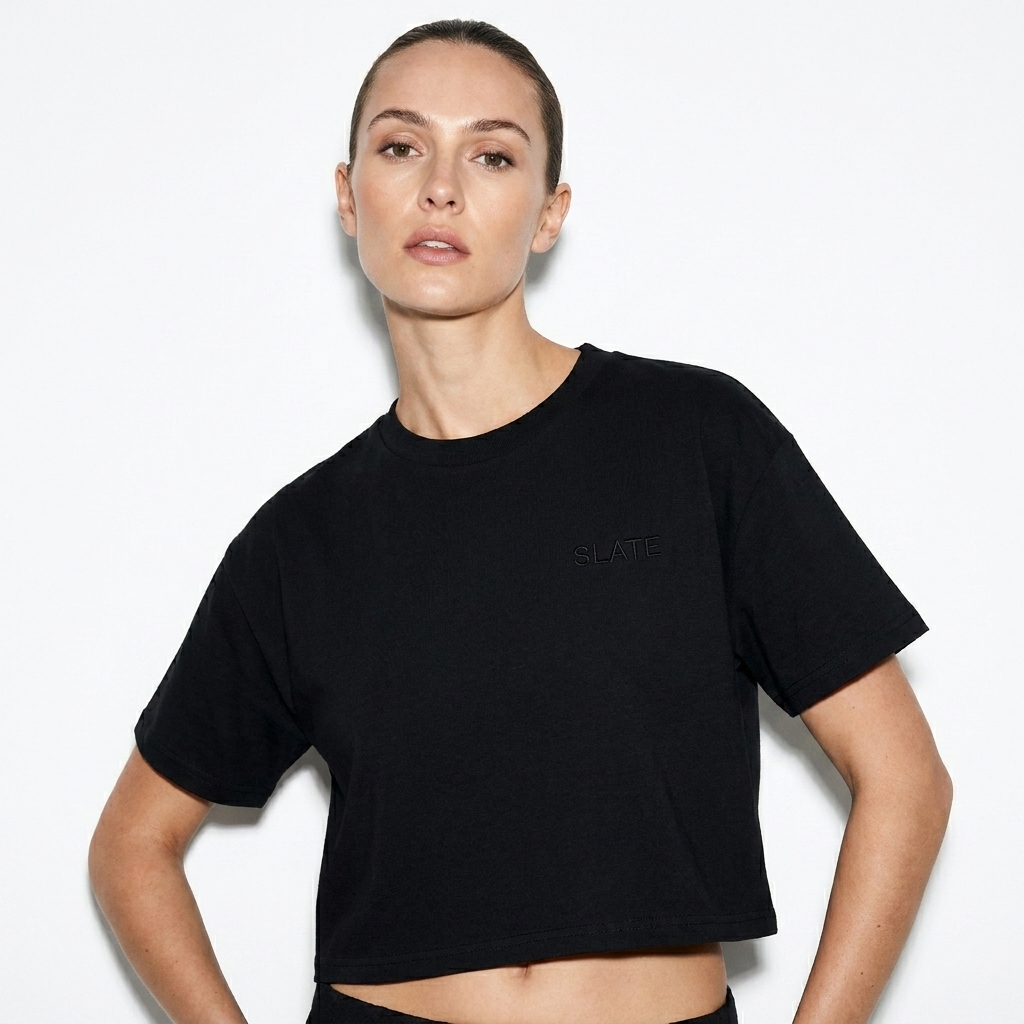 Women's Cropped T-Shirt worn by a lean British female fashion influencer, techwear modern styling, studio lookbook — custom women's cropped t-shirt