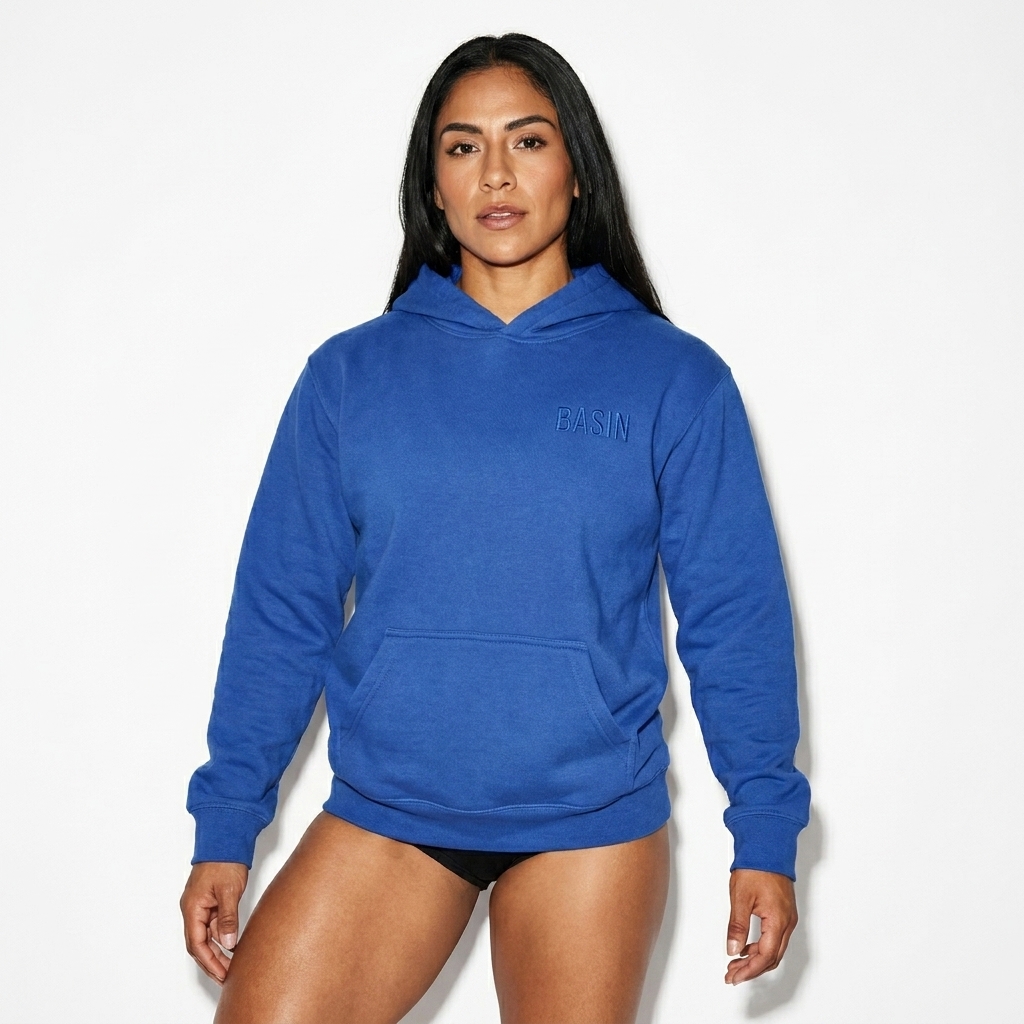 Youth Heavyweight Pullover Hoodie worn by a athletic muscular Mexican female fashion influencer, techwear modern styling, studio lookbook — custom youth heavyweight pullover hoodie